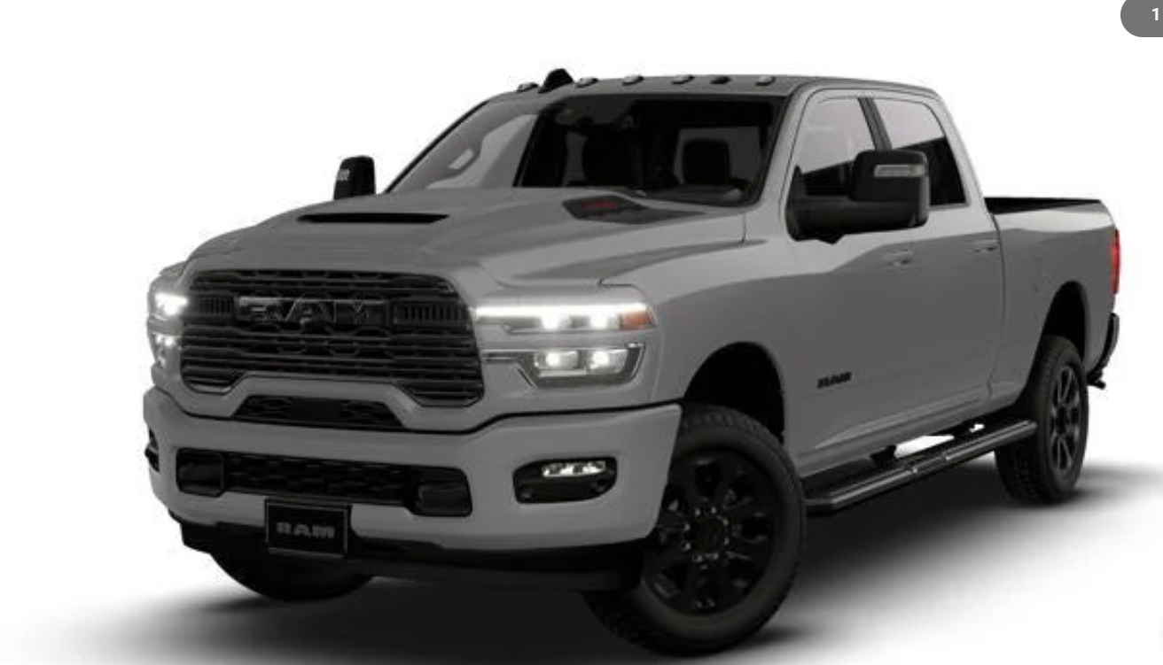 Front view of RAM 2500 truck with a bold grille, LED headlights, and black wheels