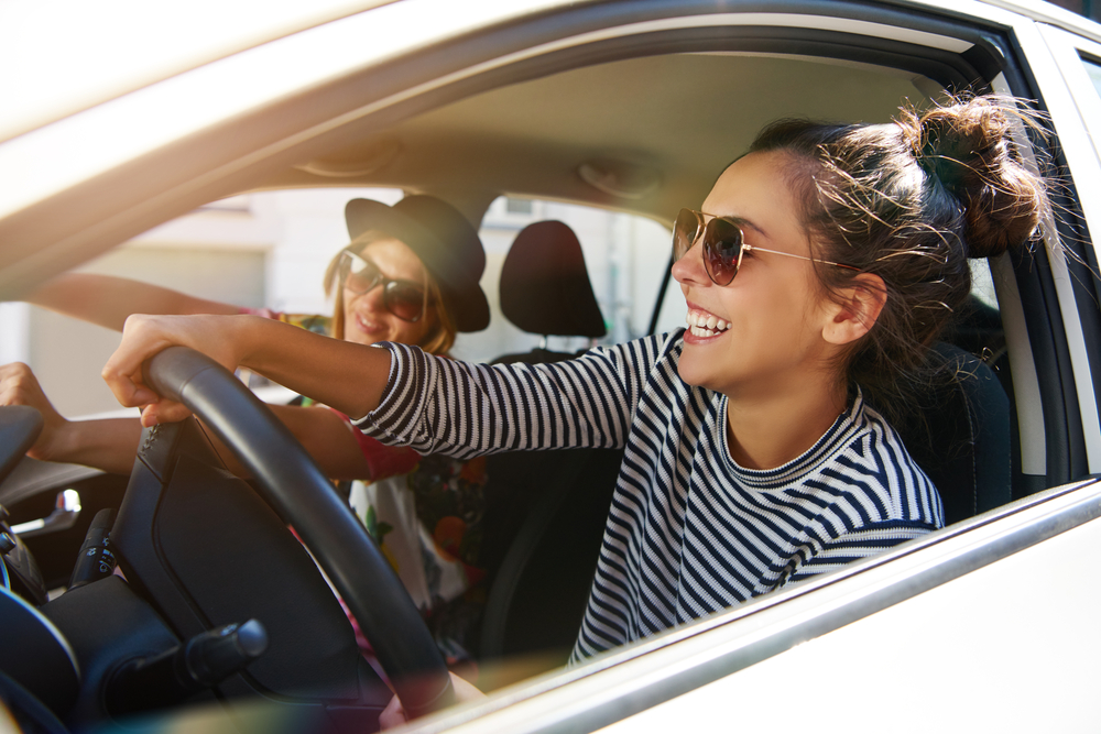 Friends enjoying a drive together inside a vehicle